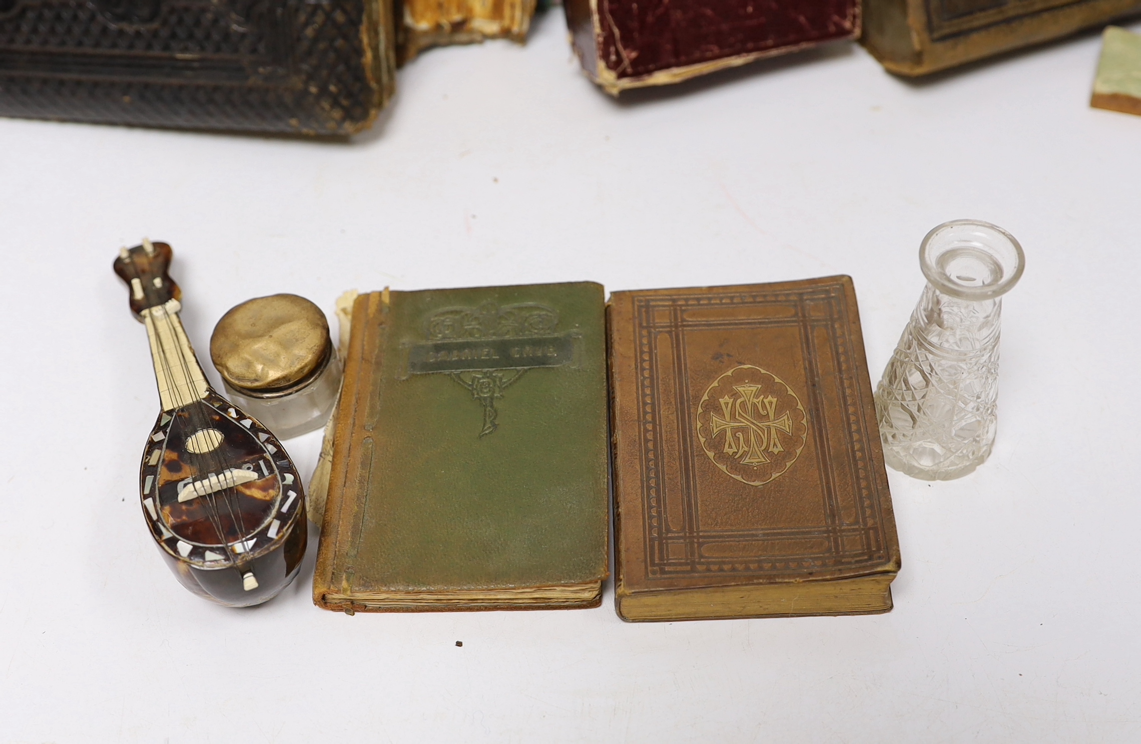 Sundry items including ephemera, empty Victorian photograph albums, bugle, miniature books, rosary and silver lidded glass pot